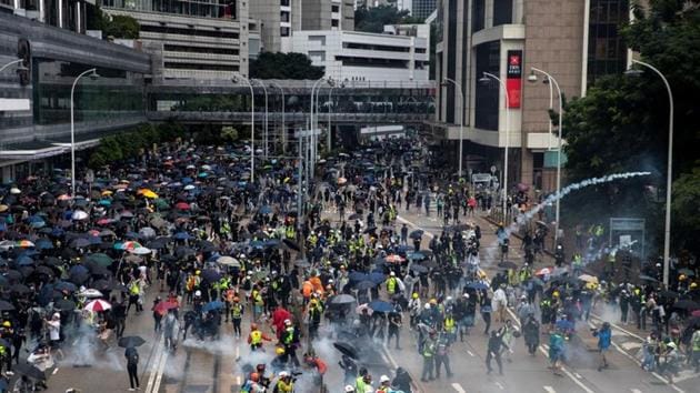 Anti-government protesters run away from tear gas during a demonstration in Wan Chai district in Hong Kong.(REUTERS Photo) Anti-government protesters run away from tear gas during a demonstration in Wan Chai district in Hong Kong.(REUTERS Photo)