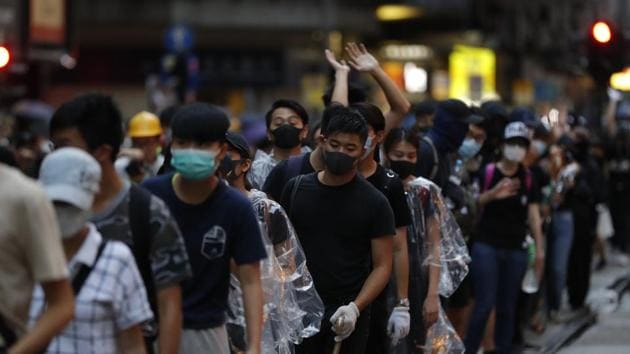 Protestors stand in line to move supplies in Hong Kong, Sunday, Oct. 6, 2019. Tens of thousands of protesters braved the rain Sunday to march in central Hong Kong as a court rejected a second legal attempt to block a mask ban aimed at quashing violence during four months of pro-democracy rallies.(AP) Protestors stand in line to move supplies in Hong Kong, Sunday, Oct. 6, 2019. Tens of thousands of protesters braved the rain Sunday to march in central Hong Kong as a court rejected a second legal attempt to block a mask ban aimed at quashing violence during four months of pro-democracy rallies.(AP)