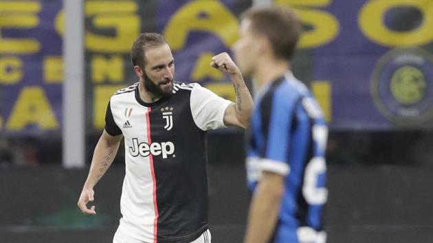 Juventus' Gonzalo Higuain celebrates after scoring his side's second goal.(AP)
