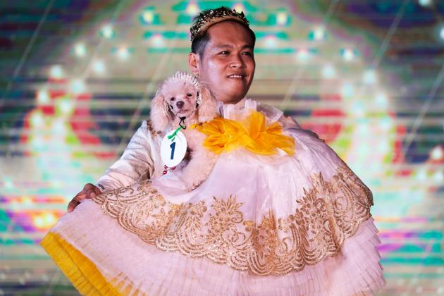 A pet owner carries his dog at a pet fashion show celebrating World Animals Day in Quezon City, Metro Manila, Philippines, October 6, 2019. (REUTERS/Eloisa Lopez)