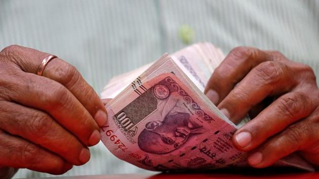 A man counts Indian currency notes inside a shop in Mumbai. (REUTERS) A man counts Indian currency notes inside a shop in Mumbai. (REUTERS)