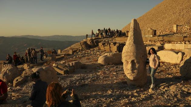 Perched at an altitude of 2,150 meters (over 7,000 feet), the statues are part of a temple and tomb complex that King Antiochus I, of the ancient Commagene kingdom, built as a monument to himself. A 50 meter (164-foot) high, man-made mound , the presumed tomb of Antiochus sets the background. (Emrah Gurel / AP)