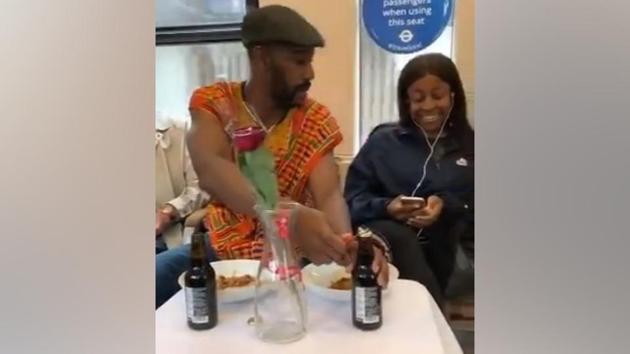 The video shows the man casually setting up a table with a vase, food and drinks.(Twitter/Elvin Mensah)