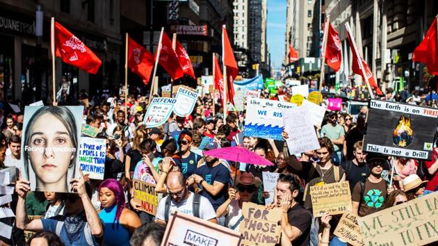 Protesters hold signs during the Global Climate Strike demonstration in New York.(Bloomberg Photo) Protesters hold signs during the Global Climate Strike demonstration in New York.(Bloomberg Photo)