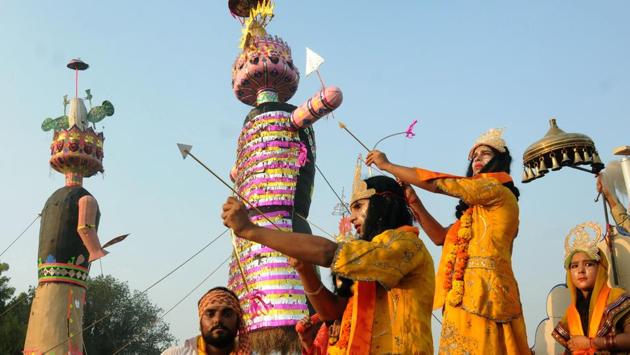 Devotees dressed as Lord Rama and Laxman aim a bow and arrow towards an effigy of the Hindu king Ravana, on the occasion of Dusshera. The festival marks the end of Ramlila and remembers Lord Ram’s victory over king Ravana. (PTI)