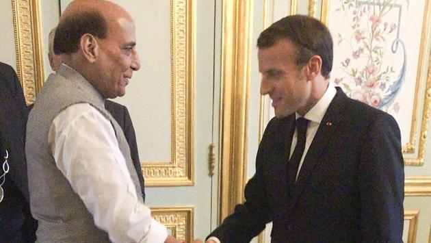 Union Defence Minister Rajnath Singh shakes hands with French President Emmanuel Macron. Both the leaders met on Tuesday to discuss stronger India-France defence and strategic ties at a meeting in Paris. (Photo: PTI)