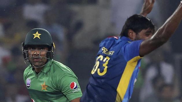 Pakistani batsman Umar Akmal, left, looks to umpire while Sri Lankan pacer Nuwan Pradeep appeals for his dismissal.(AP)