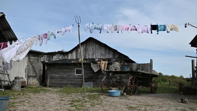 Clothes hang to dry in the yard of Izhmukhametov’s family. The nearest school then will be a 30-minute boat journey across the choppy Irtysh river followed by a 20-minute ride on the school bus. “I feel sorry for him. His parents don’t want to leave Sibilyakovo yet and it’s scary to send a little boy like him over the Irtysh, there are such big waves,” Kuchukova said. (Alexey Malgavko / REUTERS)