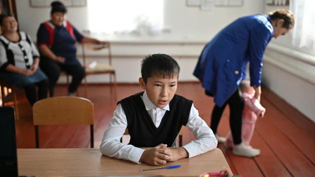 Ravil attends a class with teacher Uminur Kuchukova on the first day of the new school year in the village on September 2, 2019. Kuchukova has taught at the school for 42 years. Nowadays her house looks out onto abandoned homes on all sides. Ravil Izhmukhametov is the school’s only pupil. (Alexey Malgavko / REUTERS)