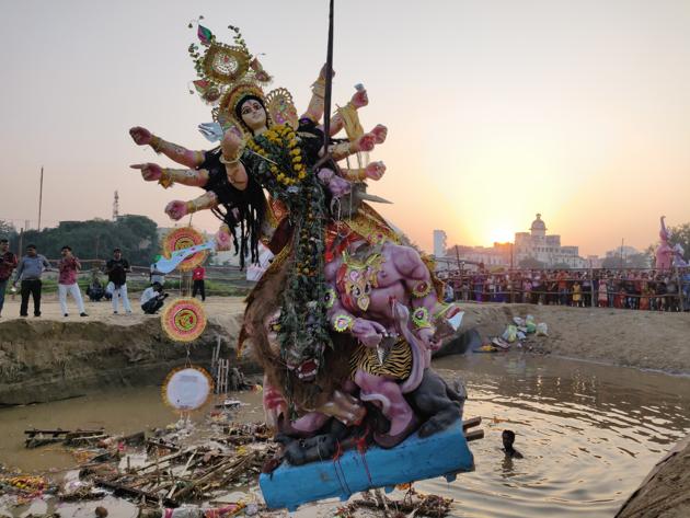 A Durga idol being immersed in a pit at Jhulelal Park, Lucknow, on Tuesday. (HT) A Durga idol being immersed in a pit at Jhulelal Park, Lucknow, on Tuesday. (HT)