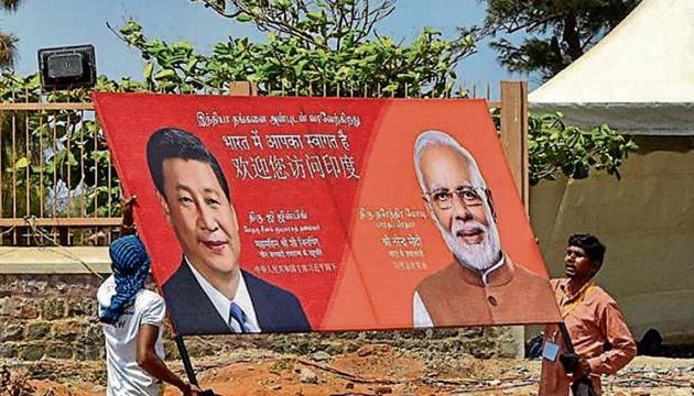 Workers carry a hoarding as preparations are underway for the summit between PM Modi and Chinese President Xi Jinping in the seaside temple town of Mamallapuram, on Wednesday. (PTI PHOTO) Workers carry a hoarding as preparations are underway for the summit between PM Modi and Chinese President Xi Jinping in the seaside temple town of Mamallapuram, on Wednesday. (PTI PHOTO)