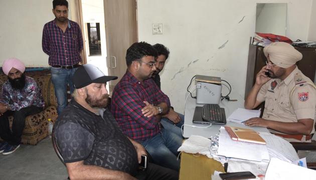 The property dealer (seated, centre) recording his statement with the PAU police in Ludhiana on Wednesday.(GURPREET SINGH/HT)