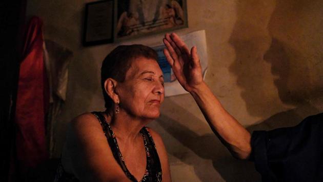 Venezuelan Rosa Saez, 77, is treated at the clinic of “Guayanese Brother”. With Venezuela’s chronic medicine shortages and hyperinflation, more and more people are turning to alternative medicine to treat common ailments in the crisis-wracked South American country. “We go to the hospital and there’s nothing there. They don’t have medicines, or they’re too expensive, what are we to do?” said Saez, who has come to get treatment for a painful arm. (Matias Delacroix / AFP)