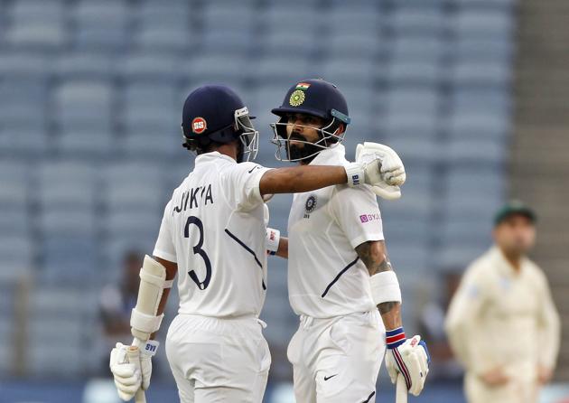 India's Virat Kohli, right, celebrates his fifty with Ajinkya Rahane during second cricket test match between India and South Africa in Pune. (AP)
