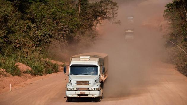 Meter-wide potholes, bone-jarring corrugations, rickety wooden bridges and billowing red dust that wipes out visibility along dirt sections of the mostly two-lane roads make them hazardous to navigate at the best of times. “That way, there’s no road,” says Fransuer, gesturing in the direction of the BR163 connecting Ruropolis and Santarem, which until recently was a rough dirt track. But it is changing. (Nelson Almeida / AFP)