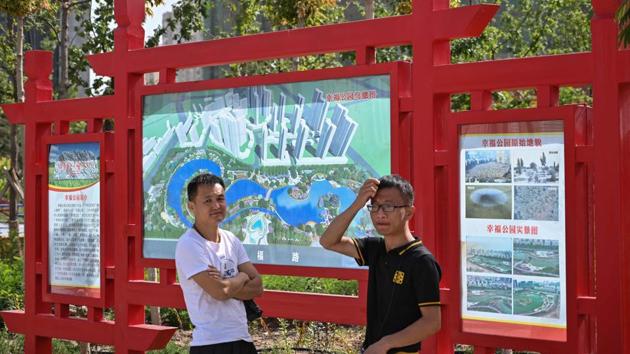 A sign at the entrance of “Happiness Park” where a Uighur cemetery was demolished. But activists and scholars say the clearances are especially shocking in Xinjiang, where they parallel the erasure of other cultural and spiritual sites, including at least 30 mosques and religious sites since 2017.”The destruction of the graveyards is very much part of the wider raft of policies,” said Rachel Harris, who researches Uighur culture at the School of Oriental and African Studies, University of London. (Hector Retamal / AFP)