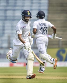 Pune: Indian cricket team players Cheteshwar Pujara and Mayank Agarwal run between the wickets during the second India-South Africa cricket test match at Maharashtra Cricket Association Stadium, in Pune. (PTI)