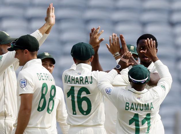 South Africa's Kagiso Rabada, right, celebrates with teammates the dismissal of India's Rohit Sharma during the second cricket test match between India and South Africa in Pune. (AP)