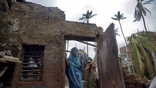 A woman stands in the remnants of her home in the aftermath of cyclone 'Fani', at the heritage crafts village Raghurajpur, in Puri district, Friday, May 10, 2019.(PTI photo)