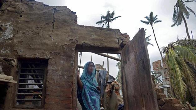 **EDS: WITH BHASHA STORY PRADESHIK6** Puri: A woman stands in the remnants of her home in the aftermath of cyclone 'Fani', at the heritage crafts village Raghurajpur, in Puri district, Friday, May 10, 2019. (PTI Photo)(PTI5_13_2019_000058B)(PTI)
