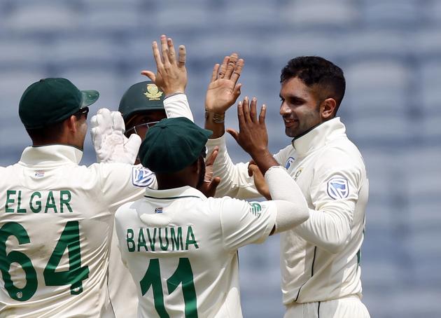 South Africa's cricketer Keshav Maharaj, right, celebrates after dismissing India's Ajinkya Rahane during the second day of the second cricket test match between India and South Africa in Pune. (AP)