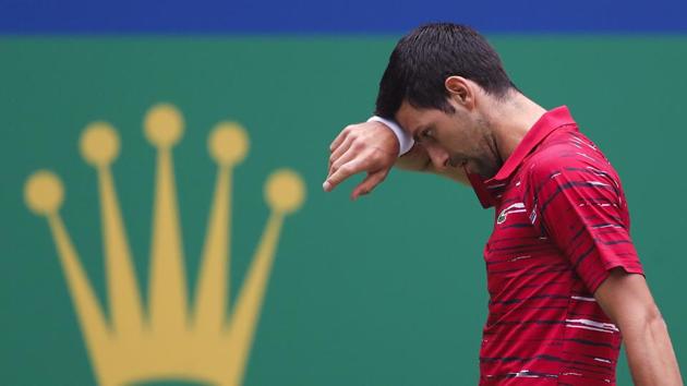 Novak Djokovic wipes his sweat as he plays against Stefanos Tsitsipas at the Shanghai Masters.(AP) Novak Djokovic wipes his sweat as he plays against Stefanos Tsitsipas at the Shanghai Masters.(AP)