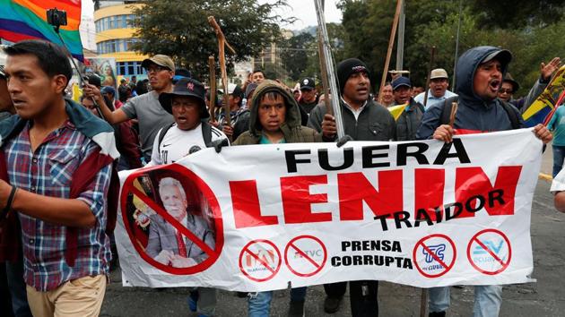 On October 8, protesters break into the Congress building. Many of them are again indigenous men armed with sticks and whips. They were evicted soon and Moreno ordered an overnight curfew to protect public buildings. (Carlos Garcia Rawlins / REUTERS)