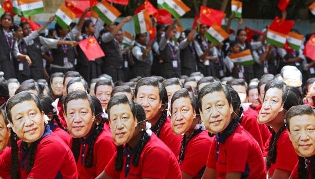 Students wear masks of China's President Xi Jinping as other waves national flags of India and China, ahead of the informal summit with India’s Prime Minister Narendra Modi, at a school in Chennai, October 10, 2019.(Reuters) Students wear masks of China's President Xi Jinping as other waves national flags of India and China, ahead of the informal summit with India’s Prime Minister Narendra Modi, at a school in Chennai, October 10, 2019.(Reuters)