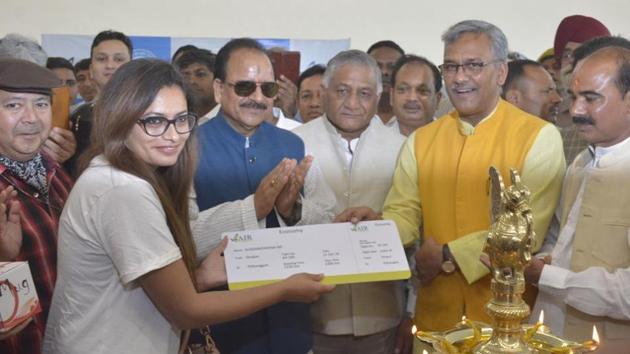 Uttarakhand chief minister Trivendra Singh Rawat felicitates one of the first passengers on the flight from the new civil terminal at Hindon Airport on Friday in Ghaziabad. (Sakib Ali/ht photo) Uttarakhand chief minister Trivendra Singh Rawat felicitates one of the first passengers on the flight from the new civil terminal at Hindon Airport on Friday in Ghaziabad. (Sakib Ali/ht photo)
