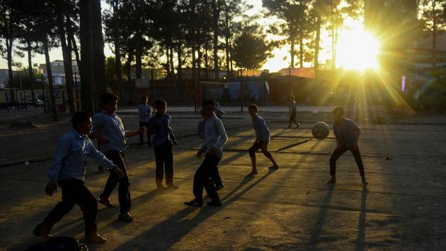 School boys play football in a park at sunset in the Herat, Afghanistan. (Hoshang Hashimi / AFP)