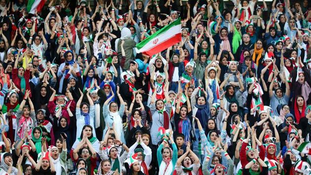 Iranian women cheer during the World Cup Qatar 2022 Group C qualification football match between Iran and Cambodia at the Azadi stadium in the capital Tehran. Women fans are attending the football match freely for the first time in decades, after FIFA threatened to suspend the country over its controversial male-only policy. (Atta Kenare / AFP)