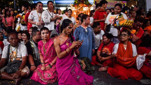 Devotees wait to receive blessings during the last day of the Navaratri Hindu festival in Bangkok, Thailand. (Lillian Suwanrumpha / AFP)