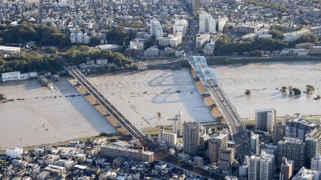 Residential areas are seen along with swollen Tama river after Typhoon Hagibis hit the area in Kawasaki, near Tokyo. In Saitama’s Higashi Matsuyama city, northwest of Tokyo, rice and flower farmers were counting their losses, with water submerging warehouses full of freshly harvested produce. “We never had a flood like this before in this neighbourhood,” said one farmer. “I don’t know where to start cleaning this mess,” he said. (Takuya Inaba / AP)