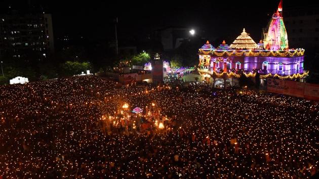 Thousands of devotees hold lamps to during “Maha Arti” for Goddess Umiya on Durgashtmi, at Umiyadham Temple, in Surat, Gujarat. (PTI)