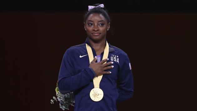 Simone Biles listens to the national anthem during the award ceremony at the Gymnastics World Championships in Stuttgart.(AP) Simone Biles listens to the national anthem during the award ceremony at the Gymnastics World Championships in Stuttgart.(AP)