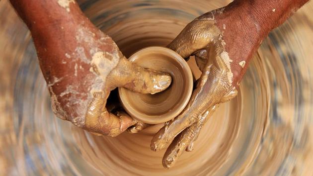 A potter makes earthen diyas ahead of Diwali, in Jammu, Jammu and Kashmir. (Nitin Kanotra / HT Photo)