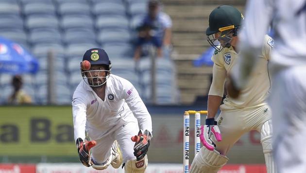 India's wicket-keeper Wriddhiman Saha dives to take a catch to dismiss South African captain Faf du Plessis.(PTI)