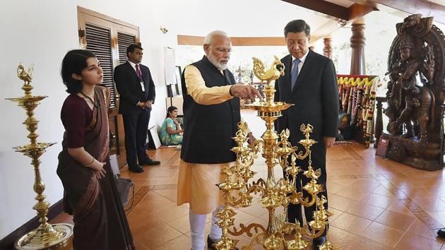 Mamallapuram: Prime Minister Narendra Modi lights a lamp as Chinese President Xi Jinping looks on, at Mamallapuram. (PTI) Mamallapuram: Prime Minister Narendra Modi lights a lamp as Chinese President Xi Jinping looks on, at Mamallapuram. (PTI)