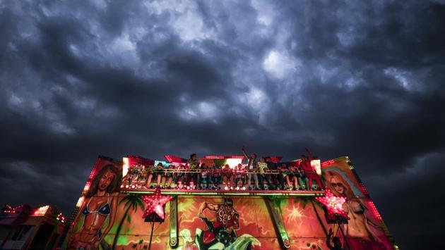 People enjoy a ride at the fair. Romania, a nation of 19.4 million, is located on the Black Sea in southeastern Europe. It is one of the poorest members of the 28-nation European Union and has struggled to fight rampant corruption. (Andreea Alexandru / AP)