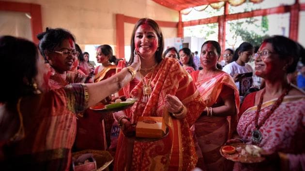 Women celebrate Sindhoor Khela on the last day of Durga Puja inside a pandal at Aram Bagh, in New Delhi. (Sanchit Khanna / HT Photo)