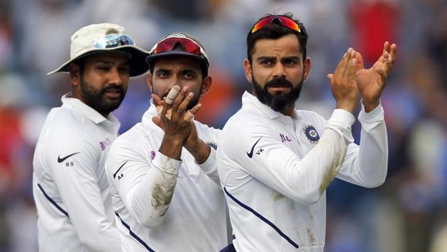 India's cricket team captain Virat Kohli, right, celebrates with teammates after winning the second test match against South Africa.(AP)