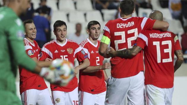 Russia's Denis Cheryshev, second left, celebrates with teammates after scoring his side's fifth goal during the Euro 2020(AP)