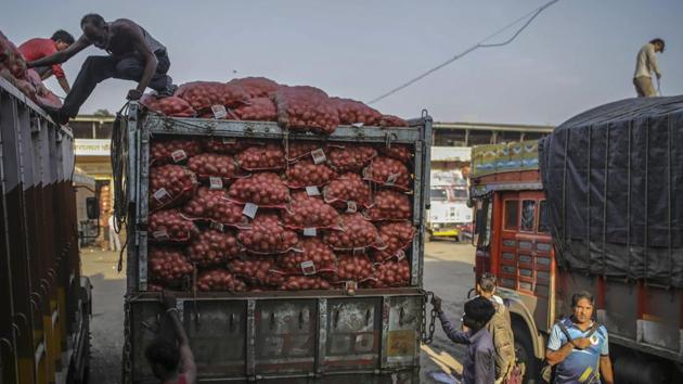 Workers unload sacks of potatoes from trucks at the Vashi Agricultural Produce Market Committee (APMC) wholesale market in Mumbai, India, on Thursday, Oct. 3 2019.(Bloomberg)