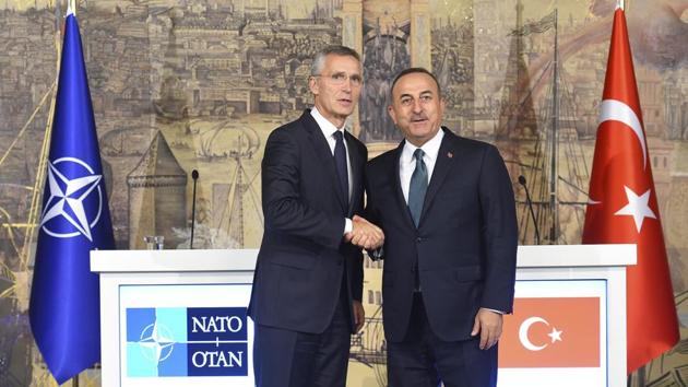 Turkish Foreign Minister Mevlut Cavusoglu (R) and NATO Secretary General Jens Stoltenberg shake hands after a joint press conference, in Istanbul, on October 11. NATO’s secretary-general said he acknowledges Turkey’s legitimate security concerns but has urged Ankara to exercise restraint in its incursion into northeast Syria. (Akin Celiktas / AP)