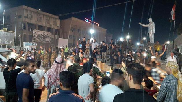 Syrians gather in the street of Hasakeh to celebrate the deal between the Damascus government and the Kurdish administration. The Kurds said that the agreement struck with the Damascus government “paves the way to liberate the rest of the Syrian cities occupied by the Turkish army such as Afrin”, a majority Kurdish enclave in the northwest. (AFP)