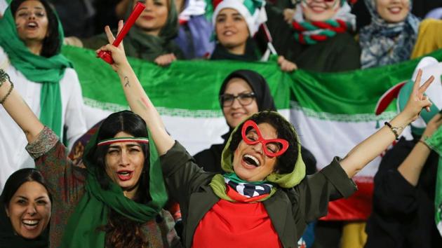 Iranian women cheer during the World Cup 2022 Group C qualification football match between Iran and Cambodia at the Azadi stadium in Tehran on October 10. The Islamic republic had barred female spectators from football stadiums for around 40 years, with clerics arguing they must be shielded from the masculine atmosphere. Women fans attended a football match freely for the first time in decades, after FIFA threatened to suspend the country over its controversial male-only policy. (Atta Kenare / AFP) Iranian women cheer during the World Cup 2022 Group C qualification football match between Iran and Cambodia at the Azadi stadium in Tehran on October 10. The Islamic republic had barred female spectators from football stadiums for around 40 years, with clerics arguing they must be shielded from the masculine atmosphere. Women fans attended a football match freely for the first time in decades, after FIFA threatened to suspend the country over its controversial male-only policy. (Atta Kenare / AFP)
