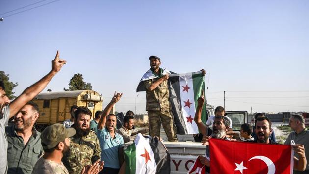 Turkish-backed Syrian opposition fighters celebrate in Akcakale, in Sanliurfa province advance, after entering over the border from Tal Abyad, Syria. State-run Anadolu news agency reported Tal Abyad had fallen to a Turkish military offensive on Sunday. (Photo: AP) Turkish-backed Syrian opposition fighters celebrate in Akcakale, in Sanliurfa province advance, after entering over the border from Tal Abyad, Syria. State-run Anadolu news agency reported Tal Abyad had fallen to a Turkish military offensive on Sunday. (Photo: AP)