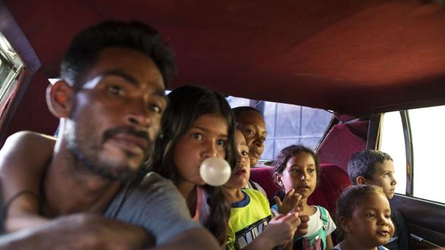 Fisherman Yanis Rodríguez and his family ride in the back of a 1970’s taxi, driven by a PDVSA state oil worker. Rodríguez used to dream of one day buying a new car and sending his eight children to private school. “But not anymore,” said Rodríguez, who lives on rationed electricity and struggles to find sources of clean water for washing, cooking and drinking. “Everything is going from bad to worse.” (Rodrigo Abd / AP)