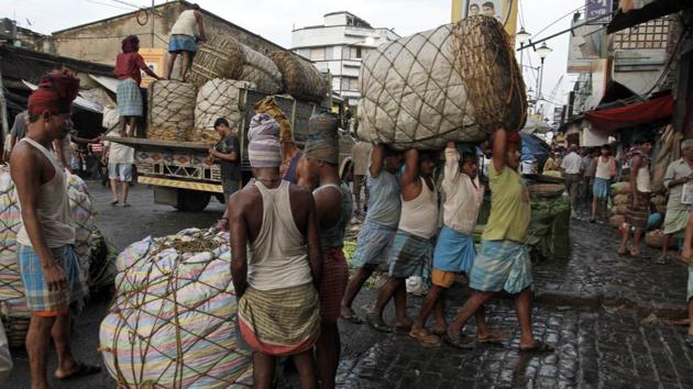 Indian laborers carry a giant basket of vegetables to a wholesale market in Kolkata, India. The world economy will grow 3% this year, down from 3.2% seen in July, IMF said. (Photo: AP) Indian laborers carry a giant basket of vegetables to a wholesale market in Kolkata, India. The world economy will grow 3% this year, down from 3.2% seen in July, IMF said. (Photo: AP)