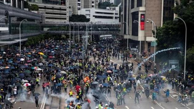 Anti-government protesters run away from tear gas during a demonstration in Wan Chai district in Hong Kong.(REUTERS Photo)